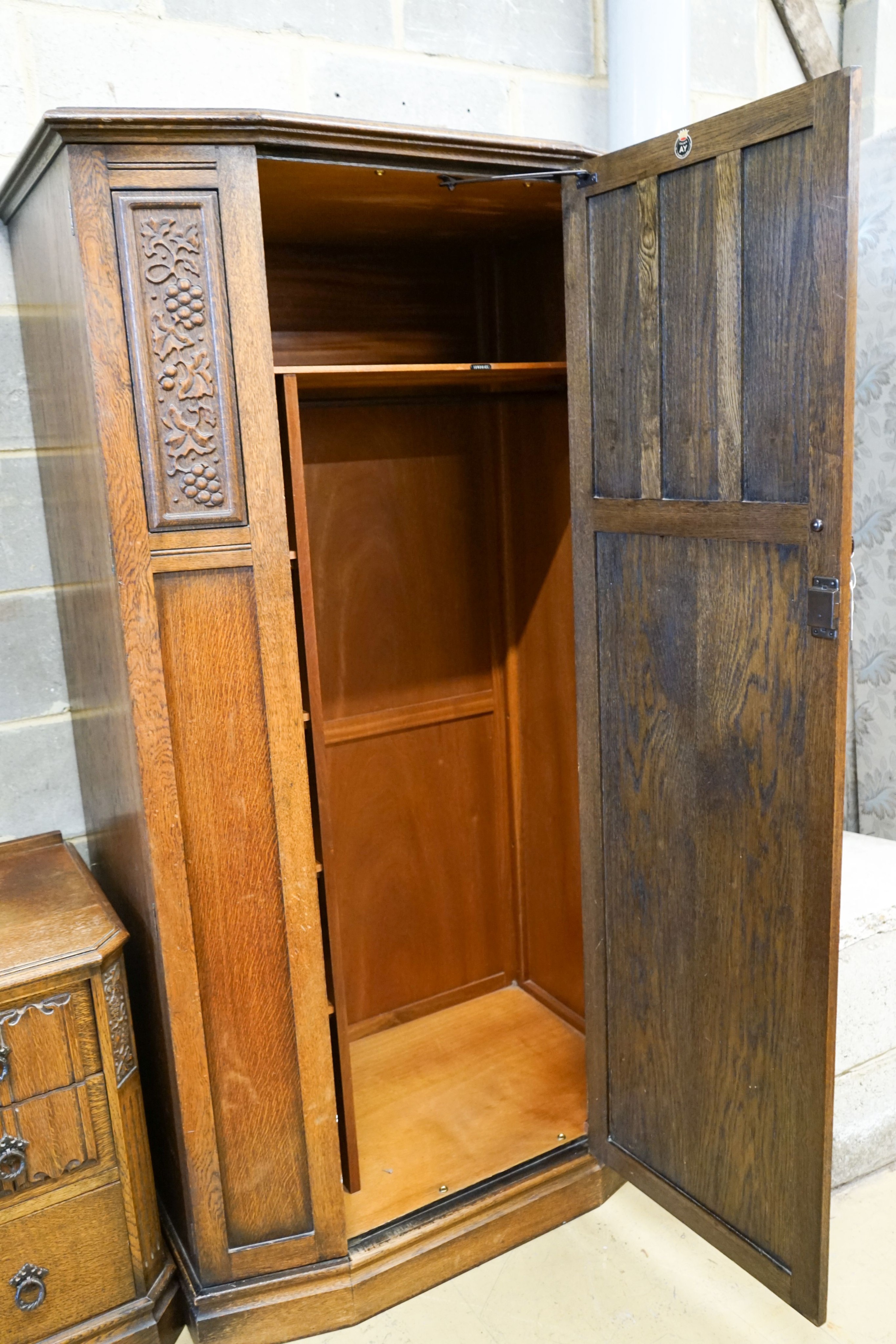 An early 20th century Jacobean revival linenfold moulded oak three piece bedroom suite, larger wardrobe length 128cm, depth 58cm, height 183cm